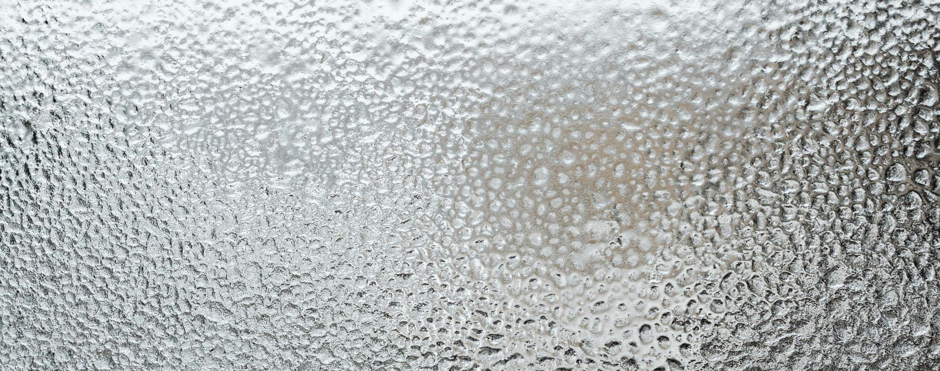 A detailed view of a frosted glass surface, capturing the icy texture and winter ambiance.
